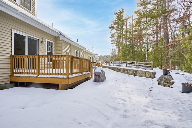 yard covered in snow with a wooden deck