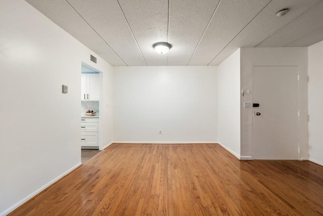 empty room with hardwood / wood-style floors