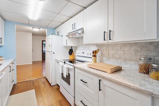 kitchen featuring white cabinetry, decorative backsplash, a drop ceiling, white appliances, and light hardwood / wood-style flooring