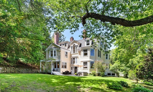 10 Eliot Rd, Lexington, MA 02421 - rear view of house featuring a chimney, a yard, a pergola, and a patio area