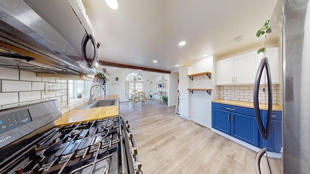 95 Prospect Street Ext, Westfield, MA 01085 - kitchen with blue cabinetry, sink, stainless steel appliances, backsplash, and white cabinets