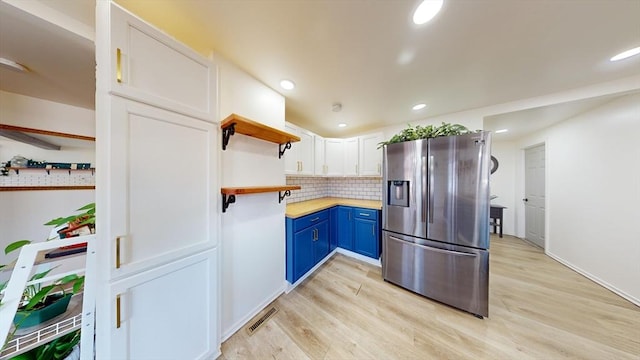 95 Prospect Street Ext, Westfield, MA 01085 - kitchen with decorative backsplash, stainless steel fridge, blue cabinets, white cabinets, and light hardwood / wood-style floors