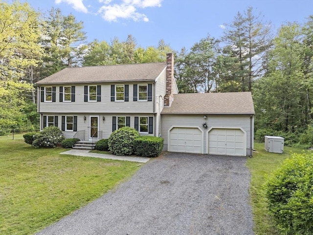 146 Lowell Rd, Pepperell, MA 01463 - colonial home with a garage, a chimney, driveway, a front lawn, and roof with shingles