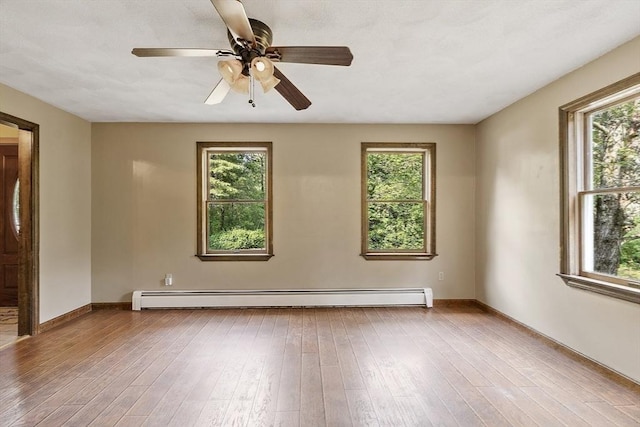 146 Lowell Rd, Pepperell, MA 01463 - unfurnished room featuring a baseboard radiator, plenty of natural light, wood-type flooring, and a ceiling fan