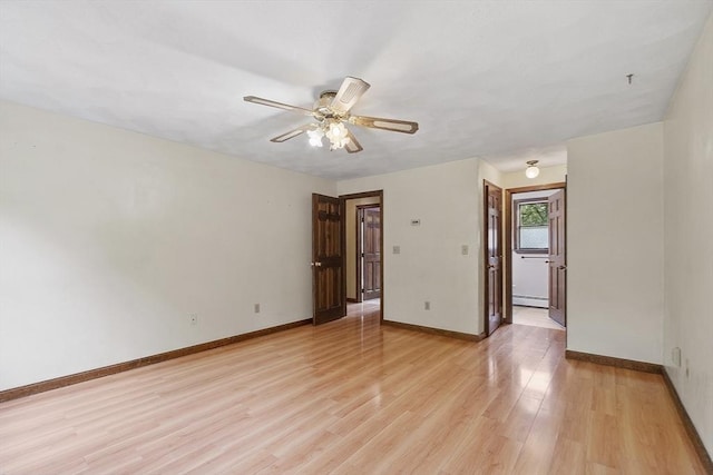 146 Lowell Rd, Pepperell, MA 01463 - empty room featuring light wood-style flooring, ceiling fan, and a baseboard heating unit