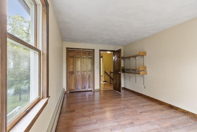 146 Lowell Rd, Pepperell, MA 01463 - unfurnished bedroom with wood finished floors and a baseboard radiator