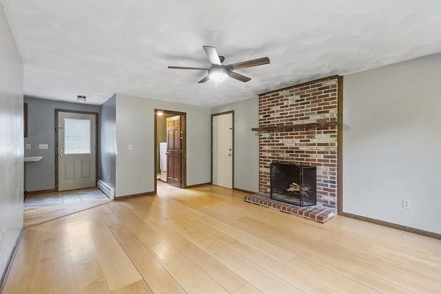 146 Lowell Rd, Pepperell, MA 01463 - unfurnished living room with a baseboard radiator, a ceiling fan, wood-type flooring, and a fireplace