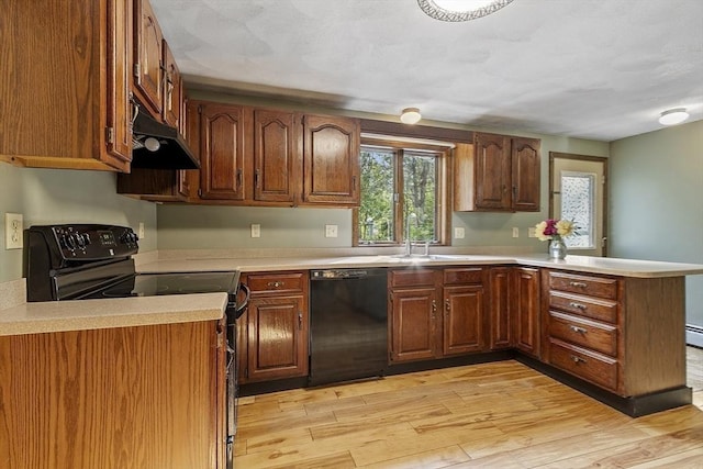 146 Lowell Rd, Pepperell, MA 01463 - kitchen featuring black appliances, under cabinet range hood, a peninsula, light wood finished floors, and light countertops