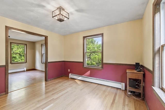 146 Lowell Rd, Pepperell, MA 01463 - unfurnished room with baseboard heating, healthy amount of natural light, and wood finished floors