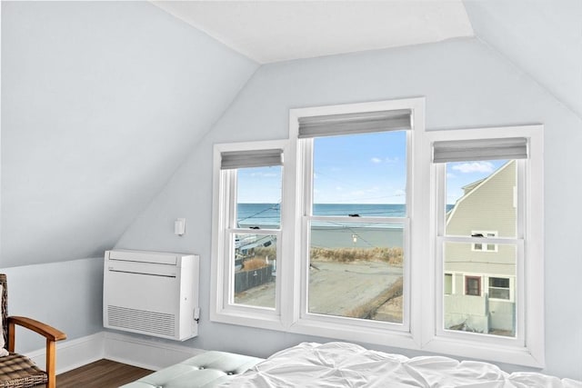 bedroom featuring vaulted ceiling, wood finished floors, and baseboards