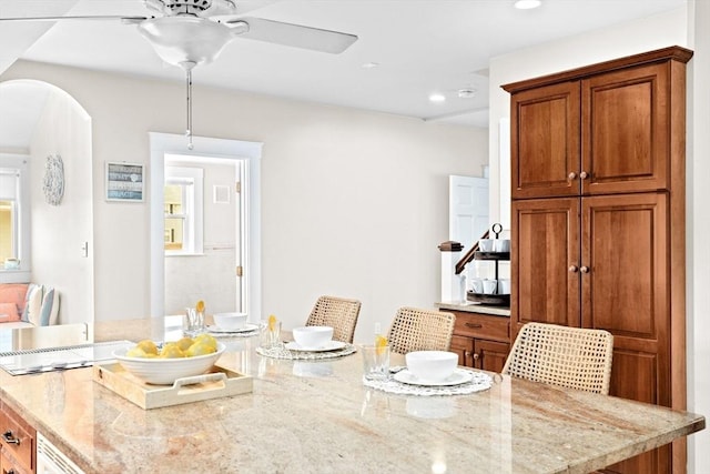 dining area featuring a ceiling fan, arched walkways, and recessed lighting