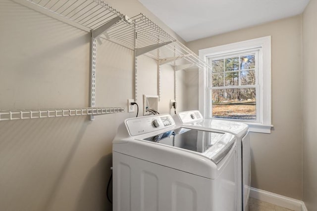 laundry area featuring laundry area, washer and dryer, and baseboards