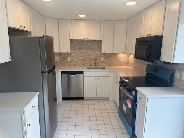 60A Washington Park Dr Unit 3, Andover, MA 01810 - kitchen with stainless steel appliances, a sink, light tile patterned flooring, decorative backsplash, and white cabinetry