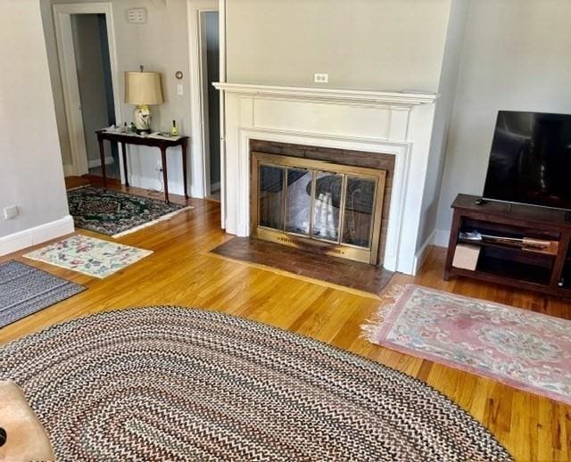 6 Damon Rd, Scituate, MA 02066 - living area with wood finished floors, a fireplace with flush hearth, and baseboards