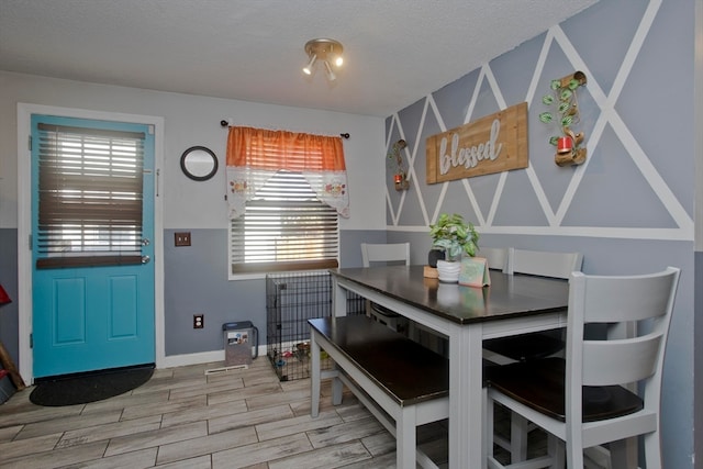 dining area with hardwood / wood-style flooring and a textured ceiling