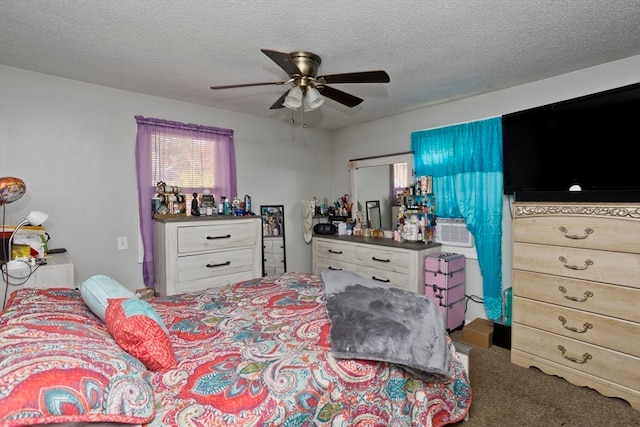 carpeted bedroom with ceiling fan and a textured ceiling