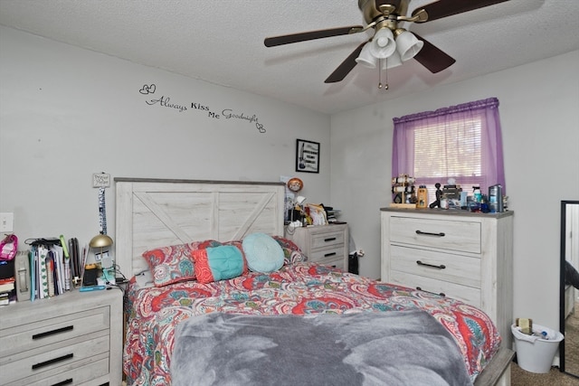 bedroom featuring ceiling fan, a textured ceiling, and carpet flooring