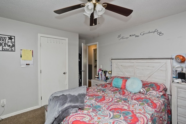 carpeted bedroom with a closet, a textured ceiling, and ceiling fan