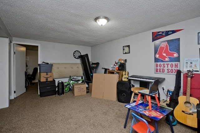 recreation room featuring carpet and a textured ceiling