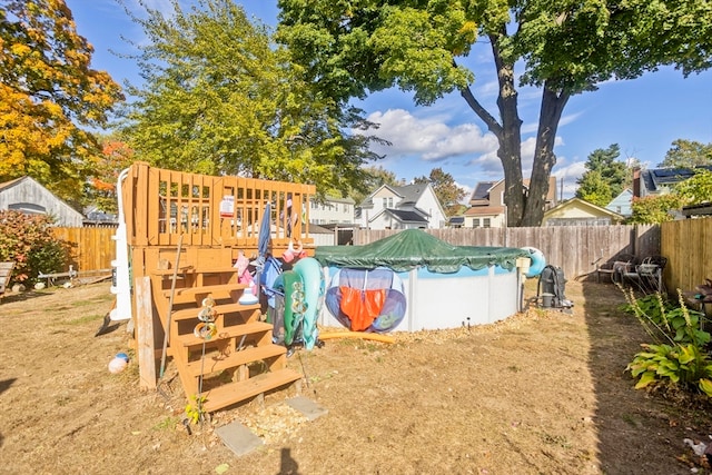 view of jungle gym featuring a covered pool