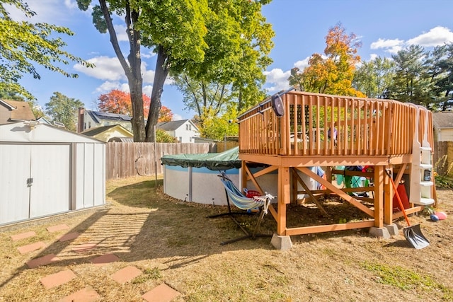 view of yard featuring a swimming pool side deck and a shed