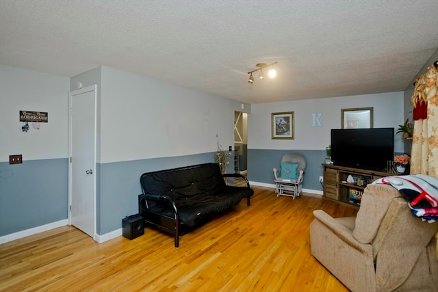 living room featuring hardwood / wood-style flooring and a textured ceiling