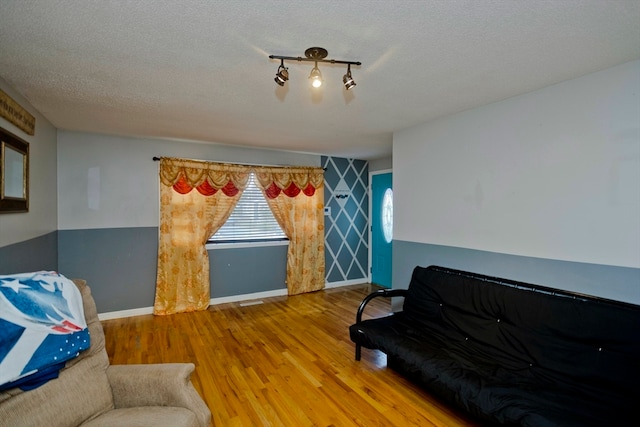 bedroom featuring hardwood / wood-style flooring and a textured ceiling