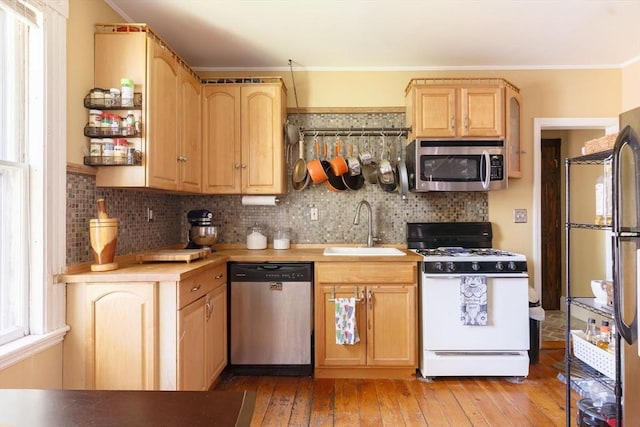 327 Lafayette St Unit 2, Salem, MA 01970 - kitchen with stainless steel appliances, light wood-style floors, ornamental molding, light brown cabinetry, and light countertops
