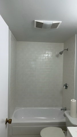 full bathroom featuring vanity, toilet, and tiled shower / bath combo