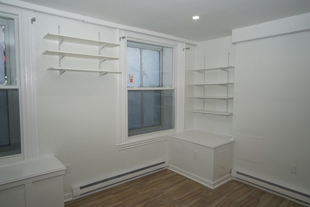 mudroom with a baseboard heating unit and dark wood-type flooring