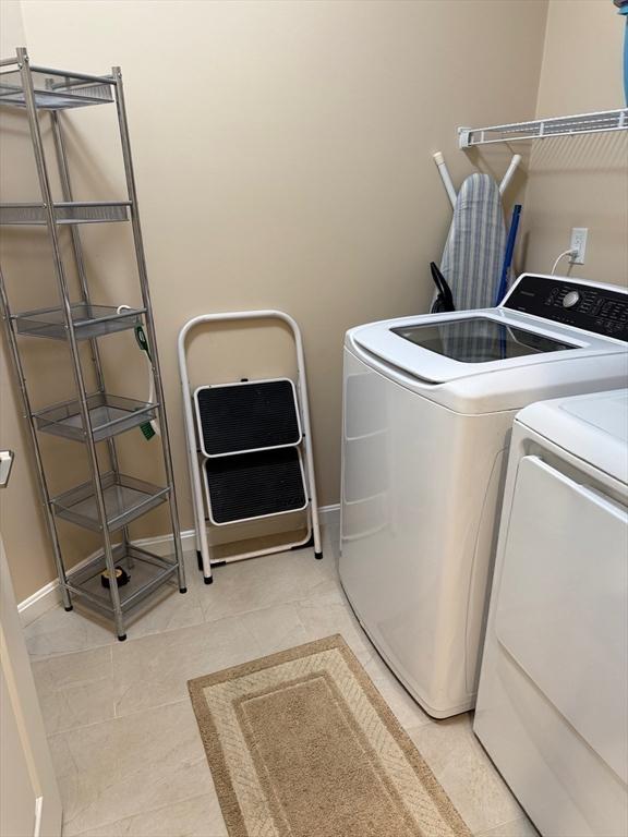 186 Stone Hill Dr Unit 186, Northbridge, MA 01588 - washroom with separate washer and dryer, baseboards, and light tile patterned flooring
