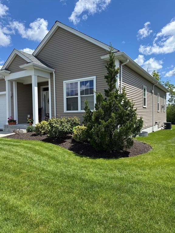 186 Stone Hill Dr Unit 186, Northbridge, MA 01588 - view of home's exterior featuring central air condition unit, a lawn, and an attached garage