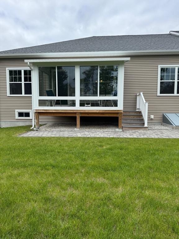 186 Stone Hill Dr Unit 186, Northbridge, MA 01588 - back of property featuring a sunroom, a yard, and roof with shingles