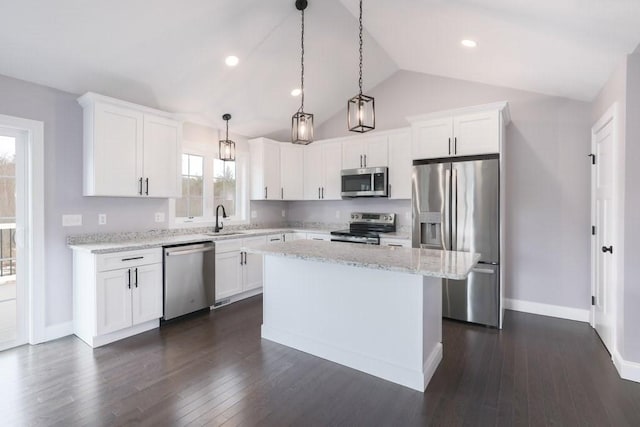 kitchen featuring a sink, white cabinets, appliances with stainless steel finishes, a center island, and dark wood finished floors