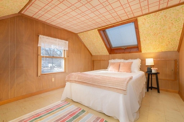 bedroom featuring tile patterned floors, wood walls, baseboards, and lofted ceiling