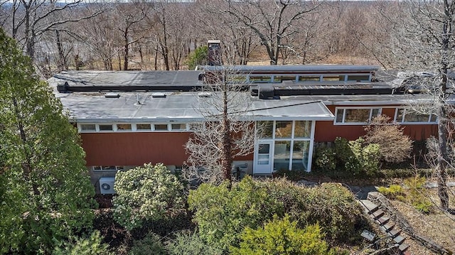 rear view of property featuring a chimney