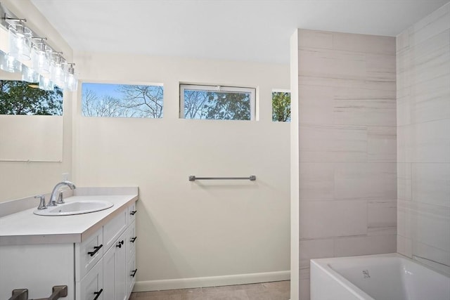 full bathroom with vanity, baseboards, and  shower combination