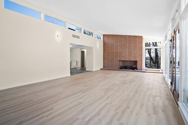 unfurnished living room with wood finished floors and a fireplace