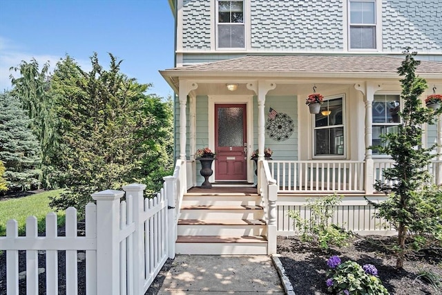 35 Harvard St, Winchester, MA 01890 - view of exterior entry featuring a shingled roof and a porch