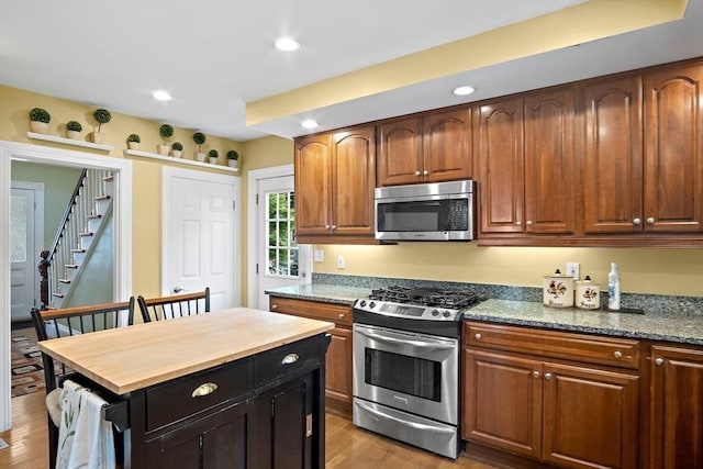 35 Harvard St, Winchester, MA 01890 - kitchen with appliances with stainless steel finishes, light wood-type flooring, wooden counters, and recessed lighting