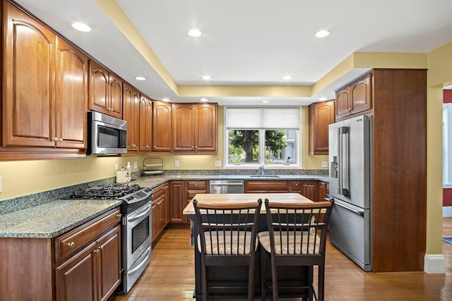 35 Harvard St, Winchester, MA 01890 - kitchen featuring stainless steel appliances, a sink, wood finished floors, recessed lighting, and light stone countertops