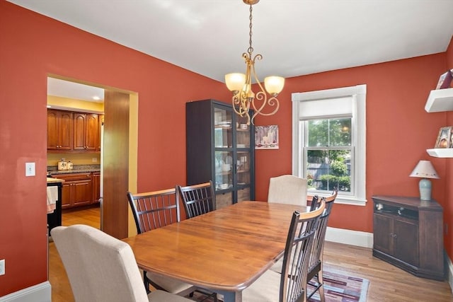 35 Harvard St, Winchester, MA 01890 - dining space featuring a chandelier, light wood-style floors, and baseboards