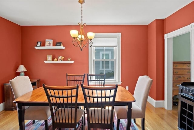 35 Harvard St, Winchester, MA 01890 - dining room featuring light wood-style floors, a chandelier, and baseboards