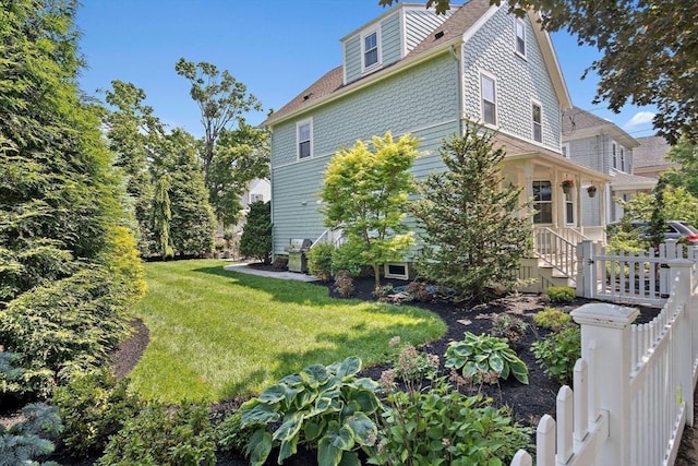 35 Harvard St, Winchester, MA 01890 - view of side of home with a lawn and roof with shingles