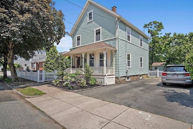35 Harvard St, Winchester, MA 01890 - victorian-style house with covered porch and a chimney