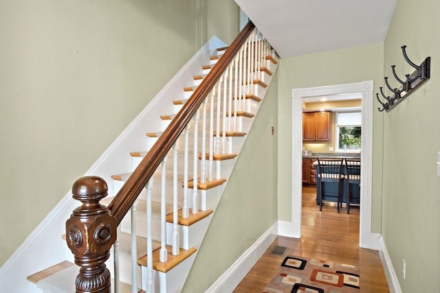 35 Harvard St, Winchester, MA 01890 - stairs featuring wood finished floors and baseboards