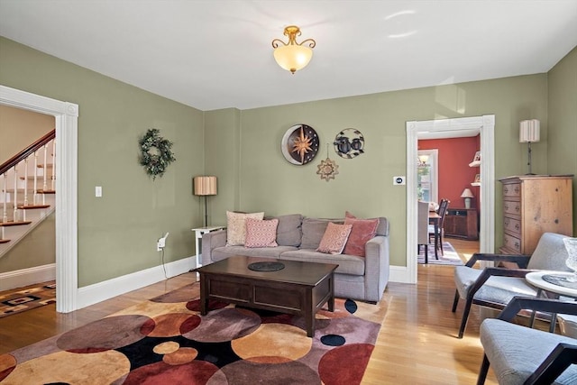 35 Harvard St, Winchester, MA 01890 - living area with light wood finished floors, stairway, and baseboards