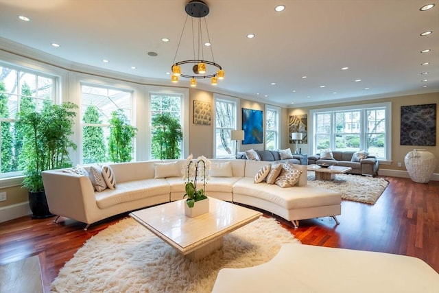 living room with ornamental molding, a healthy amount of sunlight, and dark hardwood / wood-style floors