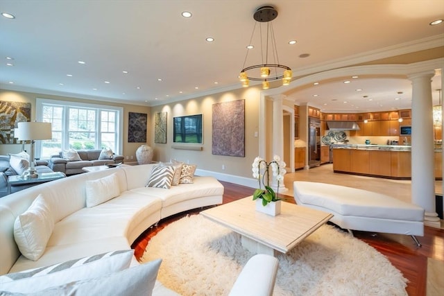 living room featuring light hardwood / wood-style floors and crown molding