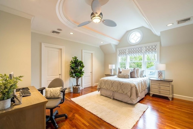 bedroom with hardwood / wood-style floors, ceiling fan, a tray ceiling, and crown molding